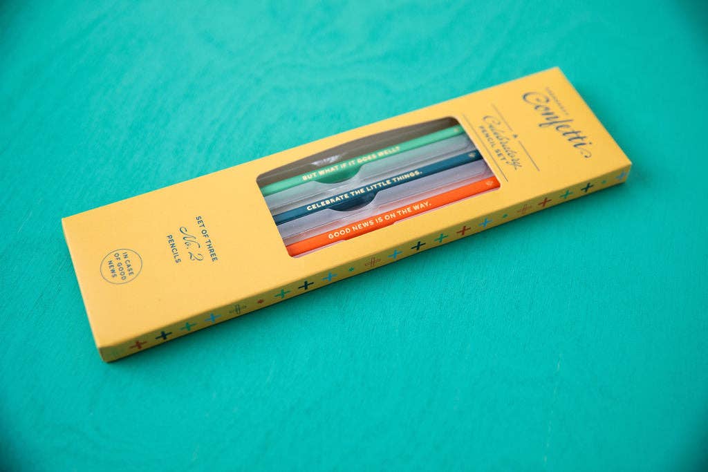 Yellow Celebratory Pencil Set box on a teal background, its window showing three pencils reading 'But what if it goes well', 'Celebrate the little things', and 'Good news is on the way'