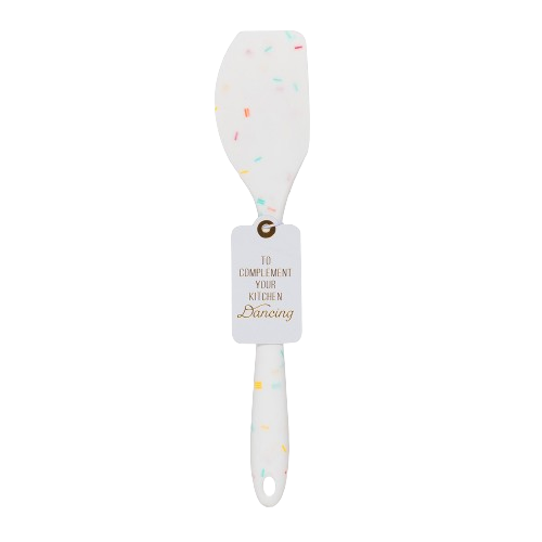 A white silicone spatula with a colorful sprinkle pattern and a hanging tag that reads 'To Complement Your Kitchen Dancing', shown on a plain white background.