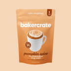 Bakercrate pumpkin spice microwavable mug cake pouch with cream cheese frosting on a light orange background