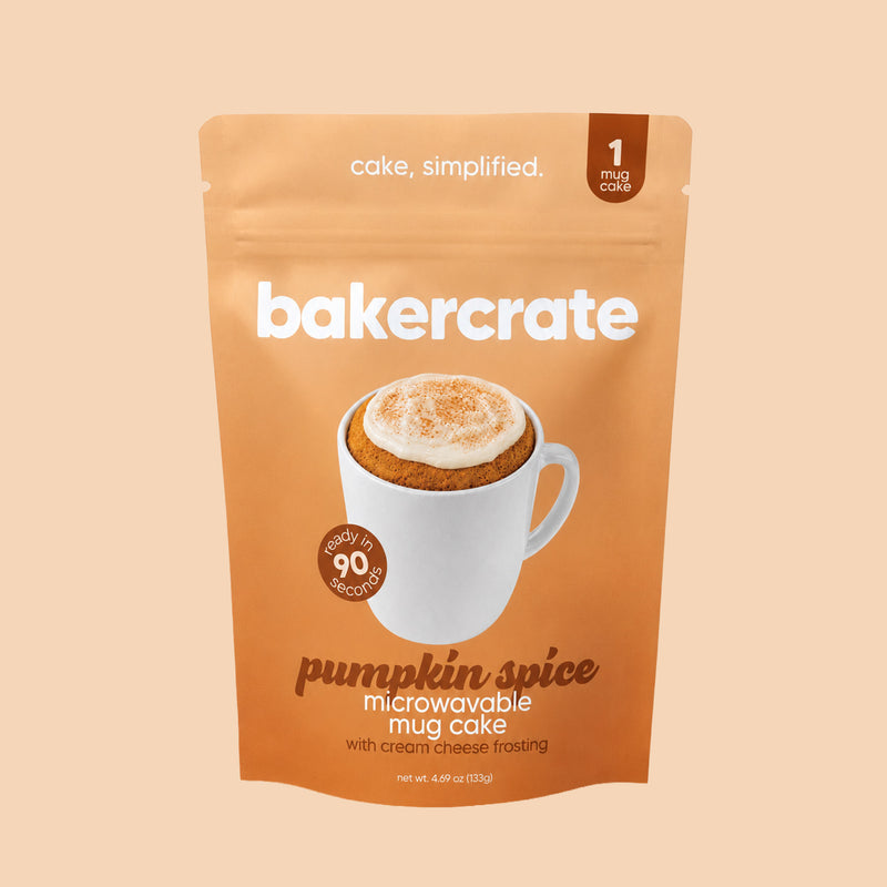 Bakercrate pumpkin spice microwavable mug cake pouch with cream cheese frosting on a light orange background