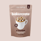 Bakercrate s'mores microwavable mug cake pouch with mini marshmallows and chocolate chips on a mauve background