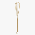 Gold mini wire whisk on white background