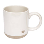 White stoneware mug with embossed heart detail on white background